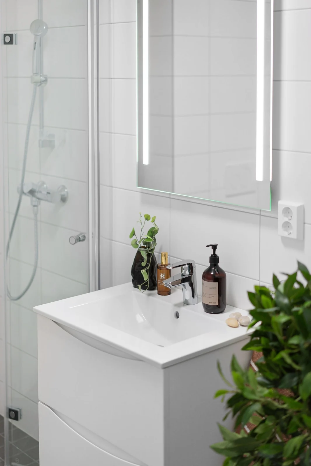 Sleek bathroom featuring a modern sink, mirror, and shower in a minimalist design