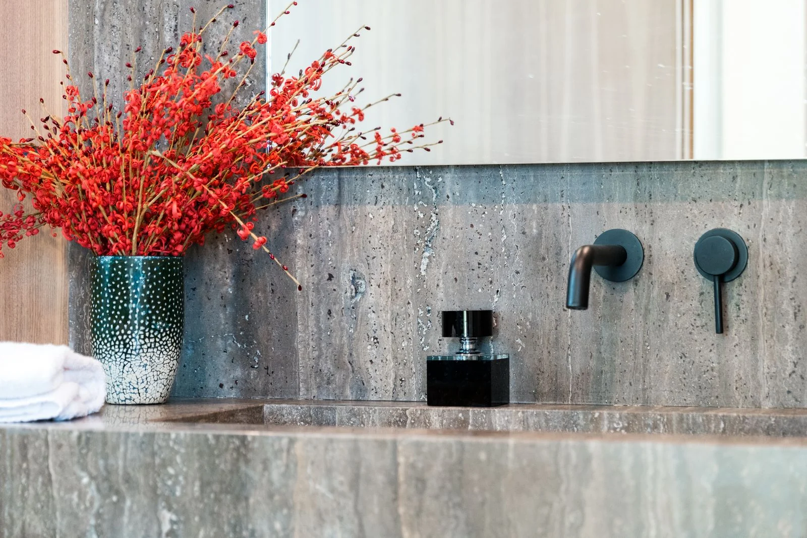 Wall-mounted tap above a basin