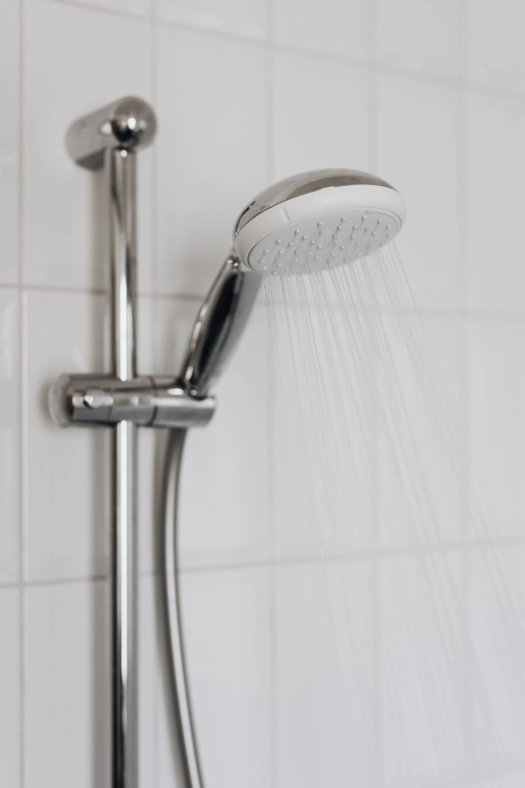 Adjustable hand shower on a rail