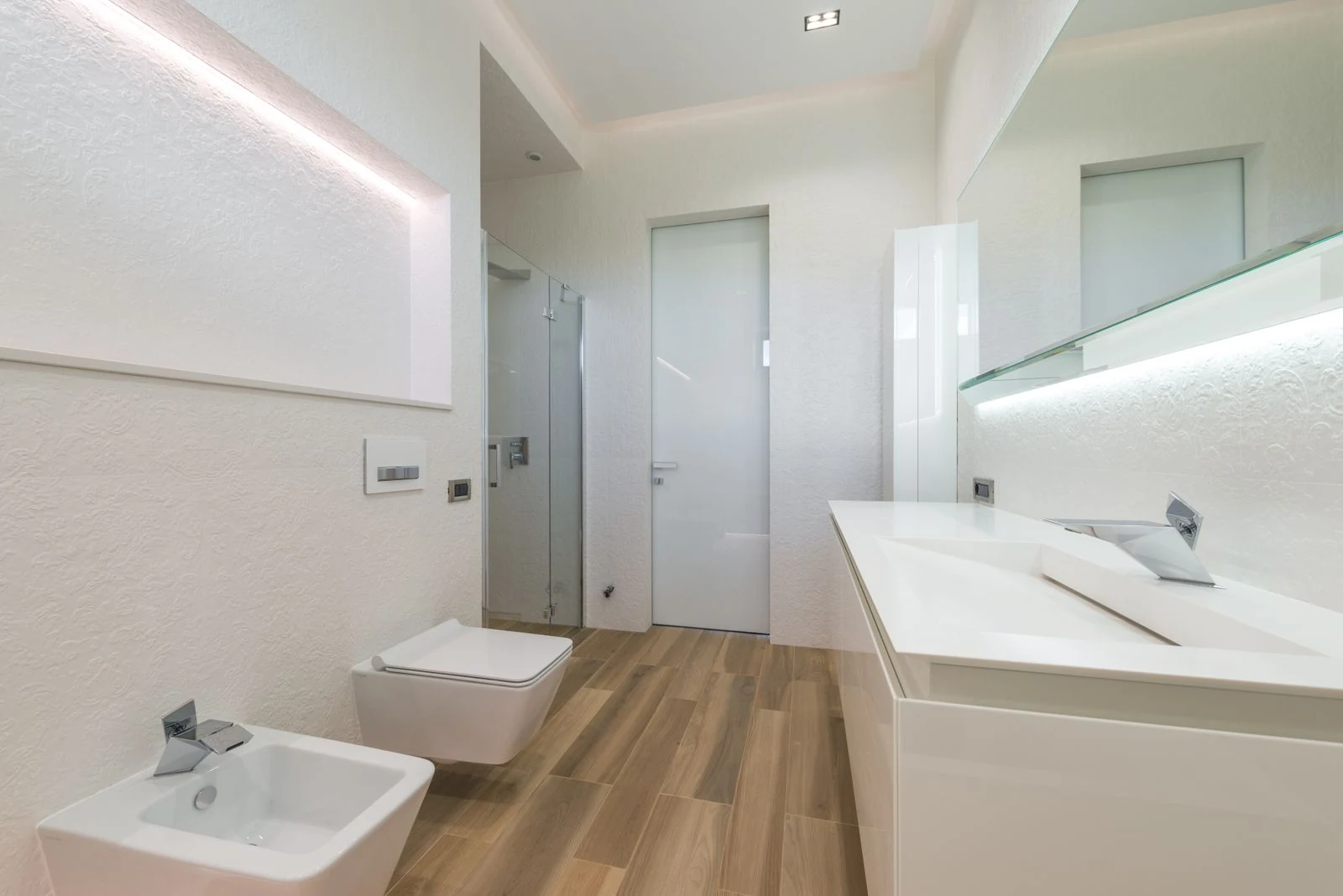 Modern home interior design of light bathroom with toilet bowl and sink in front of washbasins and mirror in contemporary house