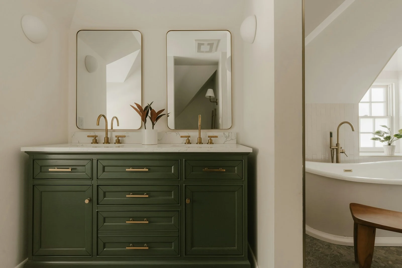 Green bathroom vanity beneath a mirror